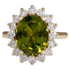 5.53 Carat Natural Peridot 14 Karat Yellow Gold Diamond Ring Stamped: 14K Yellow Gold Total Ring Weight: 5.0 Grams Total Natural Peridot Weight is 4.47 Carat (Measures: 12.00x10.00 mm) Color: Green Total Natural Diamond Weight is 1.06 Carat Color: F-G, Clarity: VS2-SI1 Face Measures: 17.75x15.65 mm Sku: [702638W] Formal Peridot Diamond Ring In Yellow Gold, Yellow Gold Cocktail Ring, Yellow Gold Diamond Ring, Peridot Stone, Gold Cocktail, La Face, Peridot Ring, Green Diamond, Green Peridot