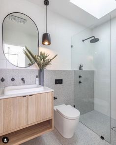 a bathroom with a toilet, sink and shower