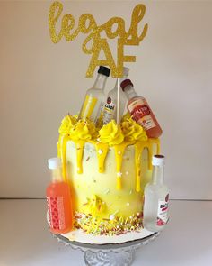 a birthday cake with yellow icing and decorations