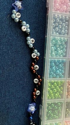 the beads are arranged in rows on the floor next to each other, with one bead hanging from it's side