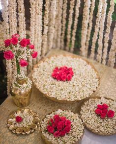 a table topped with lots of white and red flowers