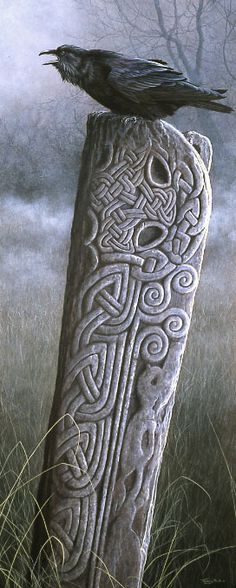 a black bird sitting on top of a stone pillar in the middle of a field