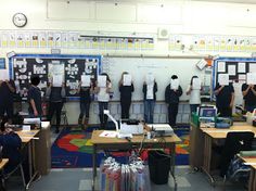 a group of people standing in front of desks