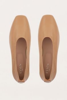 An elegant, architectural ballet flat that feels as good as it looks. Designed for everyday wear, these slip-on shoes are cut, sewn and crafted by hand from supple LWG Gold-certified leather and their shape is defined by the natural curve of the foot. The directional squared toe and flattering vamp give the humble ballet flat a simple yet modern update. DETAILS Colour: Tan Squared toe Slip-on Memory foam padding for extra comfort Leather lining and insole Heel height: 5mm/ 0.2in Handmade in Ital Brown Slip On Shoes, Ballerina Heels, Minimalist Wardrobe, Ballet Pumps, Comfortable Heels, The Foundation, Leather Ballet Flats, Leather Collar, Ballerina Flats