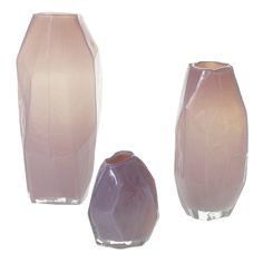 three glass vases sitting next to each other in front of a white background,