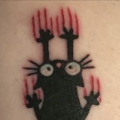 a black cat with eyes and claws on it's back side, is depicted in this tattoo design