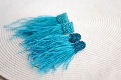 Turquoise ostrich feather earrings watterfall beaded clip on Bohemian boho tassel Statement woman gift jewelry. Birthday girlfriend gift. Christmas present. Length: about 4 inches (10 cm) They are very light! ❤ CUSTOM ORDERS It is ABSOLUTELY HANDMADE . So if you like this item in a different color or size, send me a message please. I will send you a link for a "custom order" and you'll be able to place the order there. Please feel free to communicate with me. SHIPPING Item will be shipped carefu Handmade Turquoise Tassel Earrings For Festival, Turquoise Handmade Tassel Earrings For Festivals, Elegant Blue Tassel Earrings For Festival, Elegant Blue Fringe Jewelry, Bohemian Tassel Earrings For Party, Handmade Tassel Earrings For Wedding, Unique Tasseled Jewelry, Unique Tassel Jewelry, Turquoise Beaded Fringe Jewelry Gift