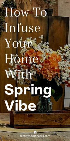 a vase filled with flowers sitting on top of a wooden table next to a sign