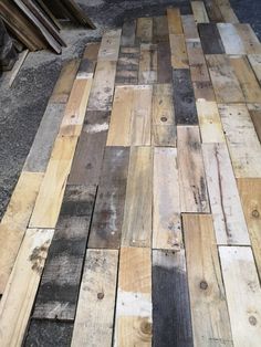 the floor is made out of wood planks and has been laid on top of each other