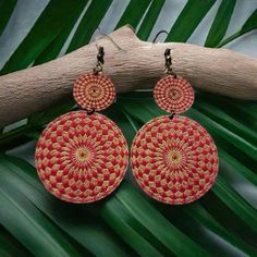 Discover the magic of mandalas with our unique wooden earrings. Each pair is a one-of-a-kind piece of wearable art, designed to inspire and uplift. The intricate geometric pattern represents balance, harmony, and the interconnectedness of all things. Perfect for the free-spirited woman who appreciates handcrafted, sustainable fashion. Why You’ll Love Them: Boho Artisan Craftsmanship: Unique Mandala design engraved into the wood. Lightweight Comfort: Perfect for all-day wear without feeling heavy Red Bohemian Circular Jewelry, Bohemian Red Round Earrings, Artisan Red Earrings For Festival, Artisan Red Festival Earrings, Red Round Earrings For Festival, Red Round Beach Earrings, Red Round Earrings For Beach, Bohemian Wooden Beads Earrings In Natural Color, Bohemian Wooden Bead Earrings In Natural Color