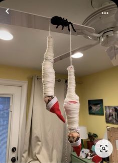 two people hanging upside down from the ceiling