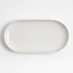 an empty white plate on a white surface