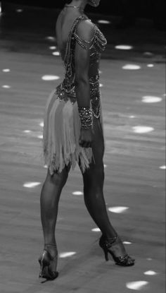 a woman in a belly dance costume is dancing