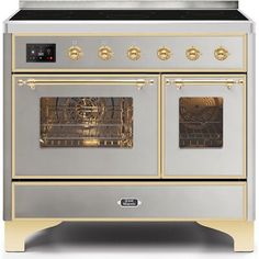 a white and copper stove with two ovens