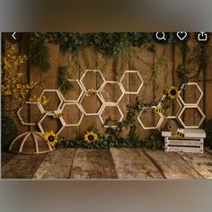 a wooden wall with honeycombs and sunflowers on it in front of a bench