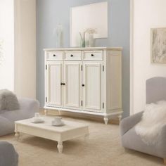 a living room filled with furniture and a white table in front of a blue wall