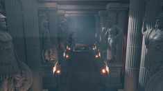 the entrance to an ancient building with statues and candles