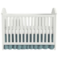 a white crib with blue ruffled bedspread