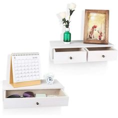 two white desks with drawers and pictures on the top one has a flower in a vase