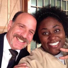 a man and woman posing for the camera with their fingers up in front of them