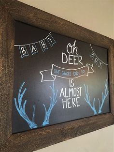 a chalkboard with some writing on it in front of a wooden framed sign that says, oh deer is almost here