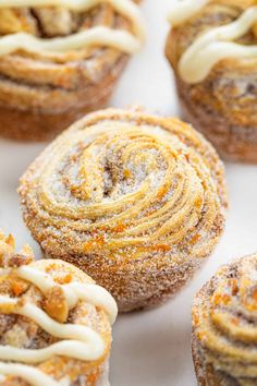 cinnamon rolls with icing sitting on top of a table