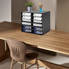 an office desk with file cabinets and chairs