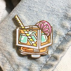 a pin with an ice cream sundae on it sitting on top of a sweater