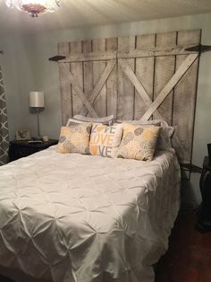 a bed with white sheets and yellow pillows