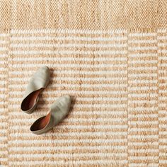 two pairs of shoes sitting on top of a rug