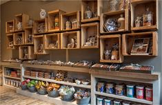 the inside of a store with shelves full of food and spices on display in wooden crates