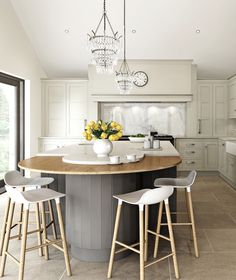 a large kitchen island with stools in the middle and yellow flowers on it's countertop