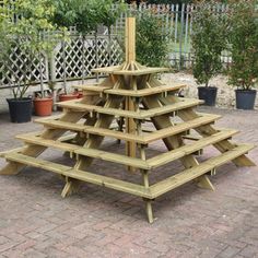 a wooden christmas tree sitting on top of a brick patio