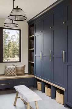 a room with blue cabinets and a bench