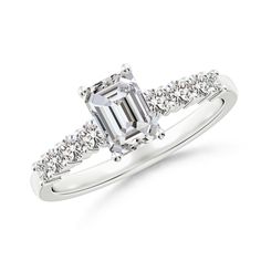 an emerald cut diamond engagement ring with side stones on the band and shoulder, set in 18k white gold