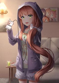 a girl with long hair holding a cell phone in her hand and wearing a hoodie