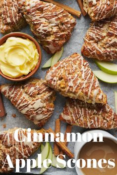 cinnamon apple scones on a tray with apples, cinnamon sticks and caramel sauce