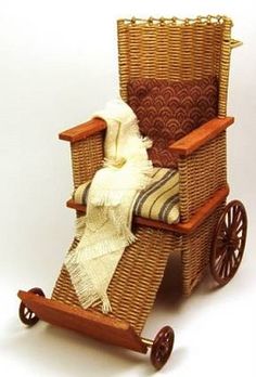 a wicker baby carriage with a blanket on it