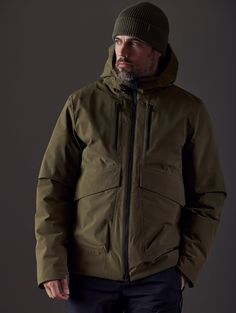 Front body view of man wearing Silverton Down Jacket in Command Green from AETHER Apparel. Men's Luxury Outdoor Outerwear, Technical Outdoor Midweight Outerwear, Military Style Windproof Outerwear For Outdoor, Ski Fashion Men, Gore-tex Winter Outerwear For Outdoor, Winter Must Haves, Gore-tex Outdoor Outerwear With Pockets, Winter Outerwear, Ski Fashion