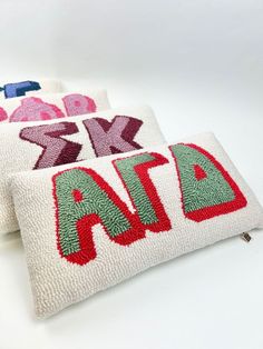 two decorative pillows with the word aid on them