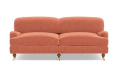 an orange couch sitting on top of a white floor