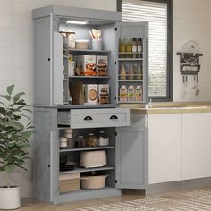 an open cabinet in the middle of a kitchen