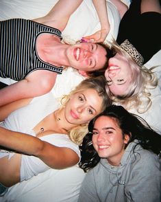 four people laying on top of each other