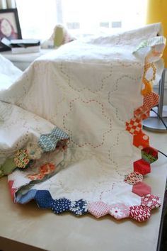 several pieces of fabric are laid out on a table