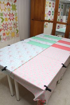 a table with several pieces of fabric on it