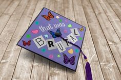 a purple graduation cap with butterflies and words that says, that was bruva