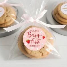 three cookies wrapped in cellophane and tied with ribbon on top of each cookie