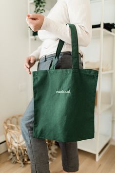 Our Essential custom name embroidered tote bag is made to order and personalized with your name on it! This tote bag is the perfect size to carry all of your daily essentials, making it perfect as a casual everyday bag or a reusable grocery tote. Perfect for yourself, mom, bridesmaids, teachers, Christmas or Bday gift! DETAILS - 100% cotton - Natural (15 1/2 in x 16 in) - Black (16 1/2 in x17 1/2 in) - Machine Embroidered HOW TO ORDER 1) From the dropdown menu, choose your tote bag color 2) In t Personalized Green Bags For Daily Use, Customizable Green Bags For Personalized Gifts, Customizable Green Bags For Daily Use, Green Embroidered School Bag, Eco-friendly Embroidered Canvas Bag As Gift, Green Bag With Embroidered Logo For Everyday Use, Embroidered Cotton Bags For Gifts, Eco-friendly Embroidered Bags As Gifts, Green Cotton Bags With Embroidery