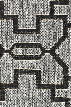 a black and white rug with an intricate design on the top, in grey tones