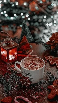 a cup of hot chocolate next to christmas decorations